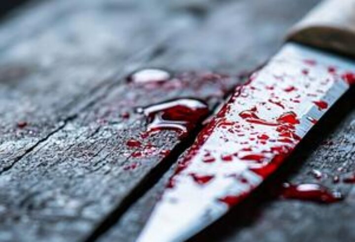 bloody-knife-with-red-splatter-on-rustic-wooden-surface-in-crime-scene-photo